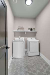 Large Laundry Room with Custom Tile Floors and Shelving.  Washer and Dryer Included