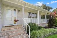 The covered front porch wraps around one side of the home.