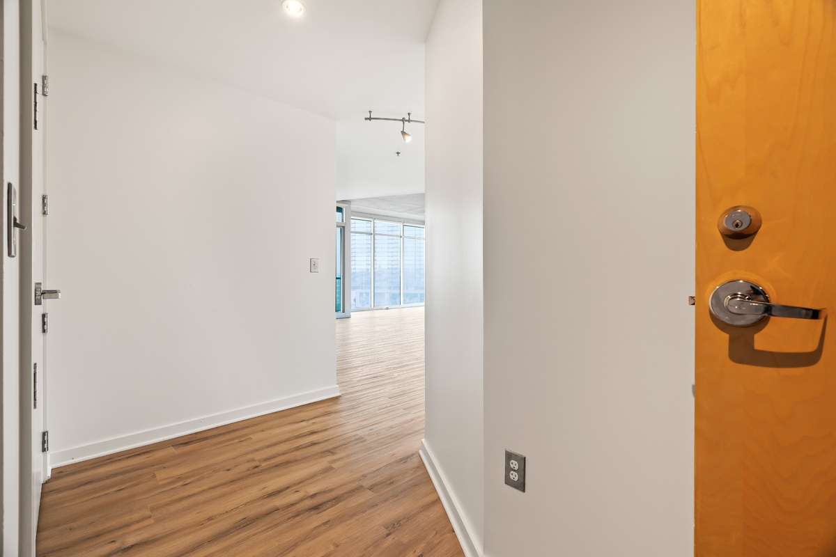 As you enter Unit 1101, you're greeted by an expansive foyer. Conveniently located near the fire exit which takes you one floor down to the 10th floor fitness center and community room. Elevator is also close by but not too close to hear.