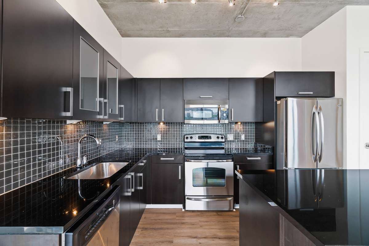 Kitchen has stainless steel appliances, glass tiled back splash, granite counter tops with moveable kitchen island.