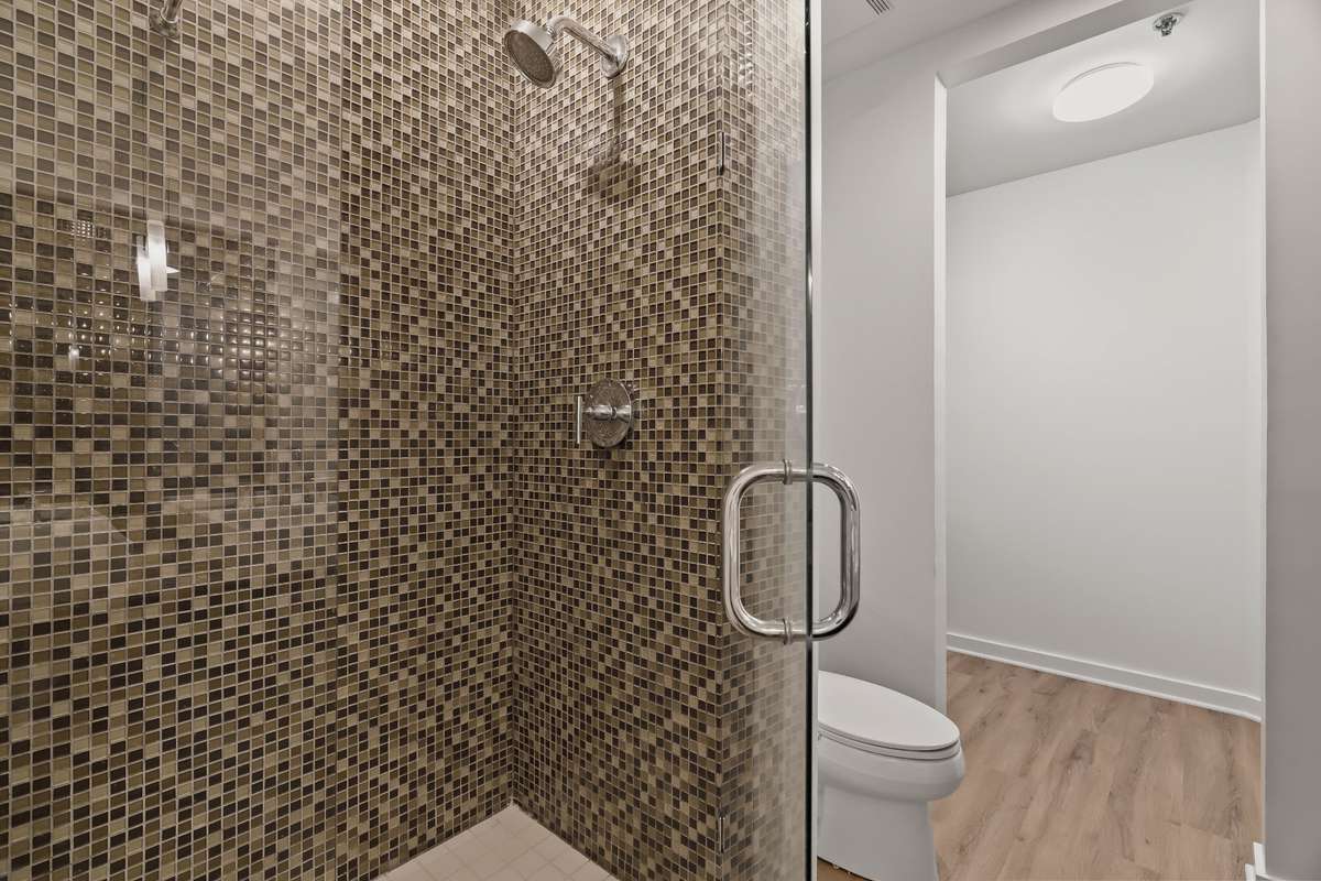 Primary Bedroom's Bathroom shower. Walk-in closet has since had a custom closet installed.