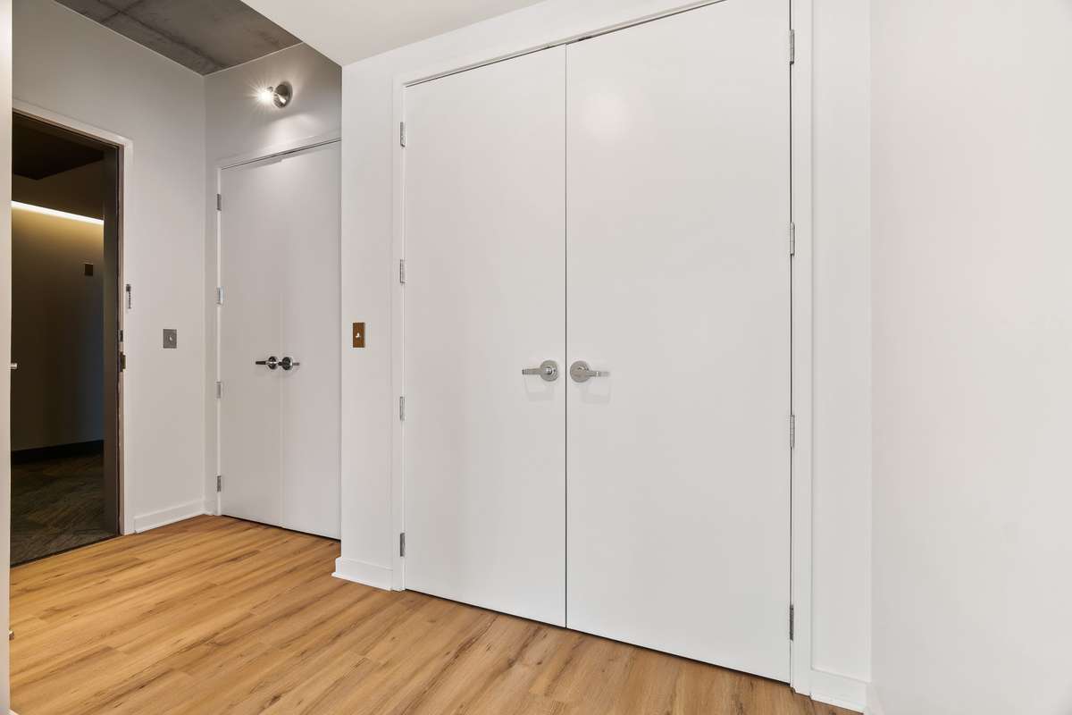 The foyer of Unit 1101 at The Icon has extra storage space. Pictured is the front coat closet and utility closet that includes a new 2024 stackable washer & dryer.