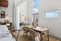 Dining with soaring windows for tremendous light