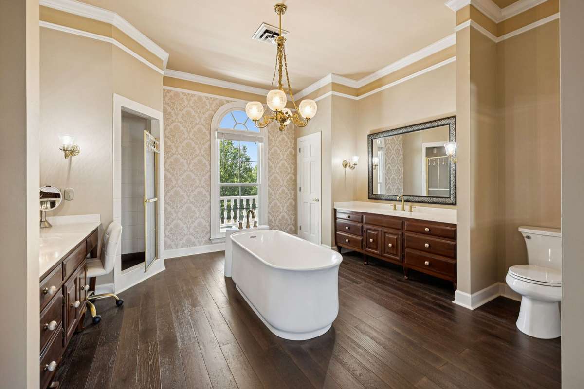 Soaking tub, double vanities and separate walk-in shower in the primary bath.