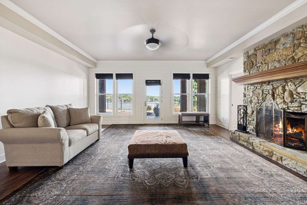 Stone fireplace is the focal point of the basement level den.