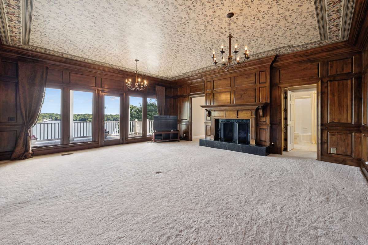 Living room is off the kitchen and beautiful lead glass doors separate.