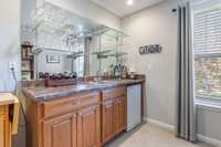 Wet bar with beverage fridge, ready to entertain.