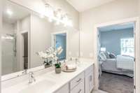 Tile flooring and double sinks provide style and function with abundant cabinet and drawer storage.