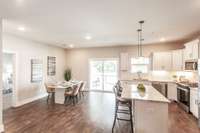 The seamless flow between the living, dining, and kitchen areas keeps everyone connected.