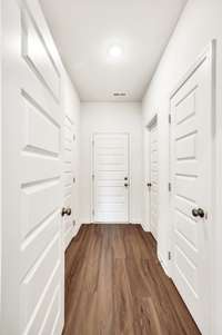 Hallway connects the laundry room, pantry, garage entry, and a large storage closet—keeping everything organized and within easy reach.