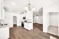 Sleek kitchen design blends style and function with ample counter space, stainless appliances, and crisp white cabinets—open to the living area for easy connection and flow.