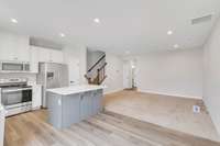 Stainless appliances and tons of white cabinets