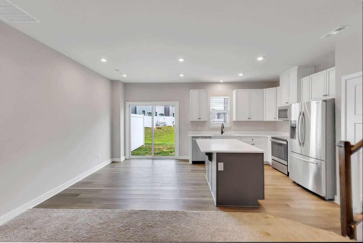 Carpet in the living area meets LVP in the kitchen