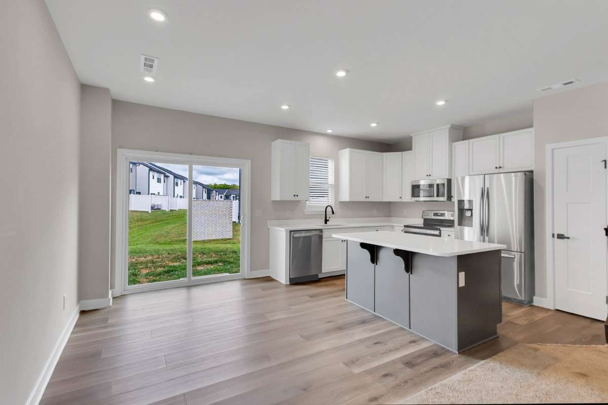 The kitchen can accommodate a large table AND a few bar stools