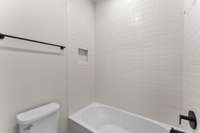 Tiled Shower with Tub in Secondary Bath.
Photo is of actual Home.