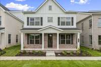 Modern Farmhouse Elevation with Full Front Porch.
Photo is of actual Home.