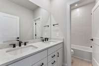 Secondary Bath with lots of cabinet storage and double sinks.
Photo is of actual Home.