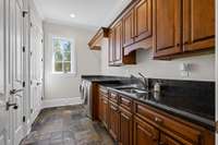 Spacious and functional, this well-appointed laundry room offers plenty of storage and workspace to keep things organized with ease.