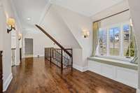 Overlooking the great room, the catwalk offers a stunning vantage point with floor-to-ceiling windows showcasing breathtaking views of Williamson County.