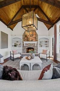 A warm and inviting retreat featuring its own fireplace, fresh flooring, and a cozy atmosphere—perfect for relaxing or gathering with friends.