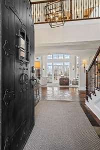 A grand and inviting entrance with elegant details, setting the tone for the warmth and sophistication found throughout the home.