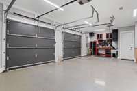 Three car garage includes ample space for storage and utility.