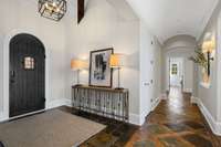 A grand and inviting entrance with elegant details, setting the tone for the warmth and sophistication found throughout the home.