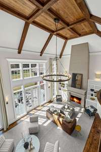 Overlooking the great room, the catwalk offers a stunning vantage point with floor-to-ceiling windows showcasing breathtaking views of Williamson County.