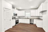 Bright kitchen with granite countertops, undermount sink, Samsung stainless appliances, and a roomy pantry. Clean lines, ample storage, and efficient layout make this space as practical as it is polished.