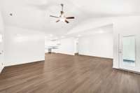 Wide-open living area designed for flexibility—furnish it your way with room for a sectional, dining table, or workspace. Vaulted ceiling and recessed lighting give the space an airy, upscale feel that lives larger than expected.