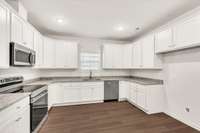 Abundant cabinetry and a clean, functional layout make cooking effortless and enjoyable.