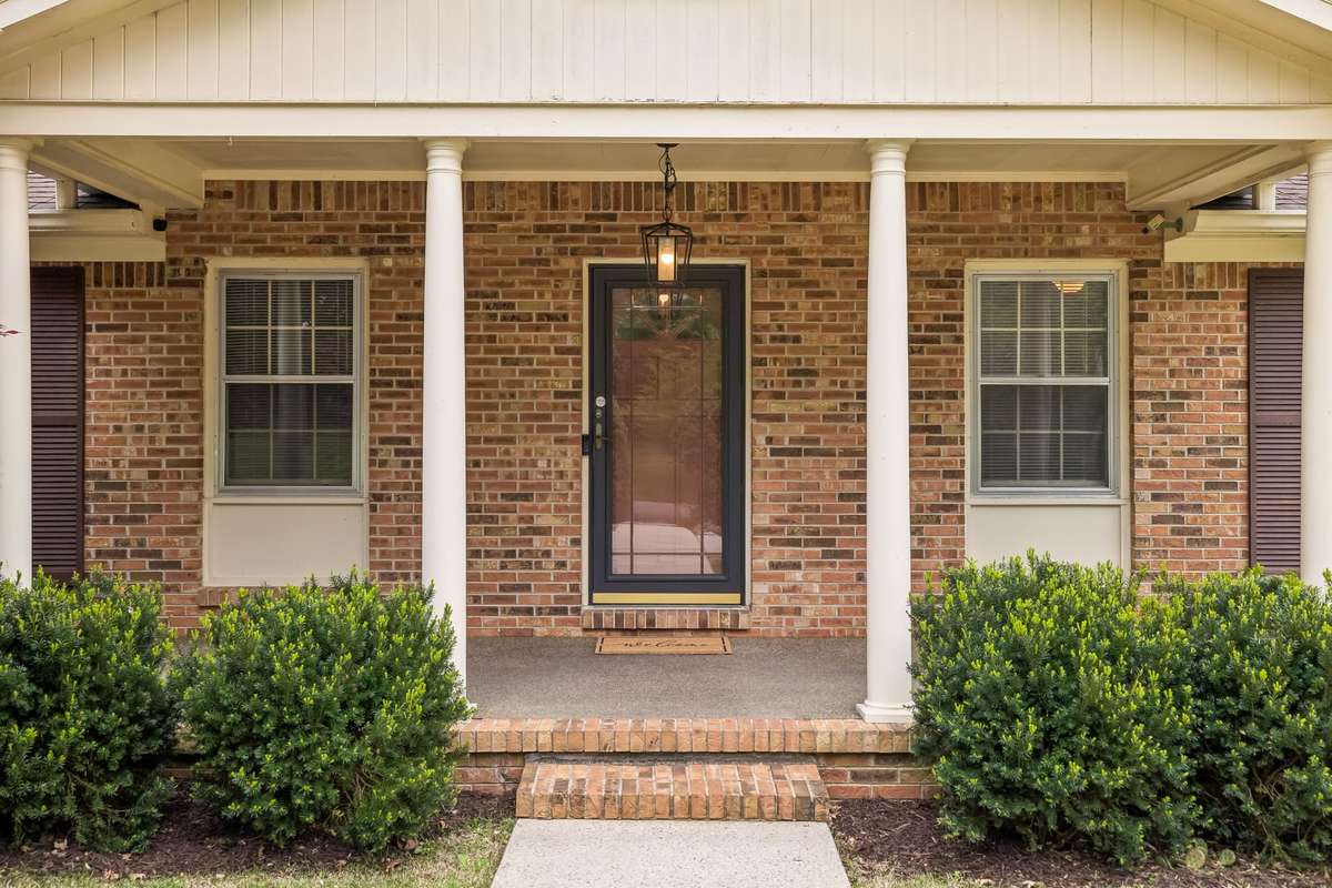 Characterized by its enduring brick craftsmanship and wide, inviting profile, this residence stands as a testament to quality design and pride of ownership.