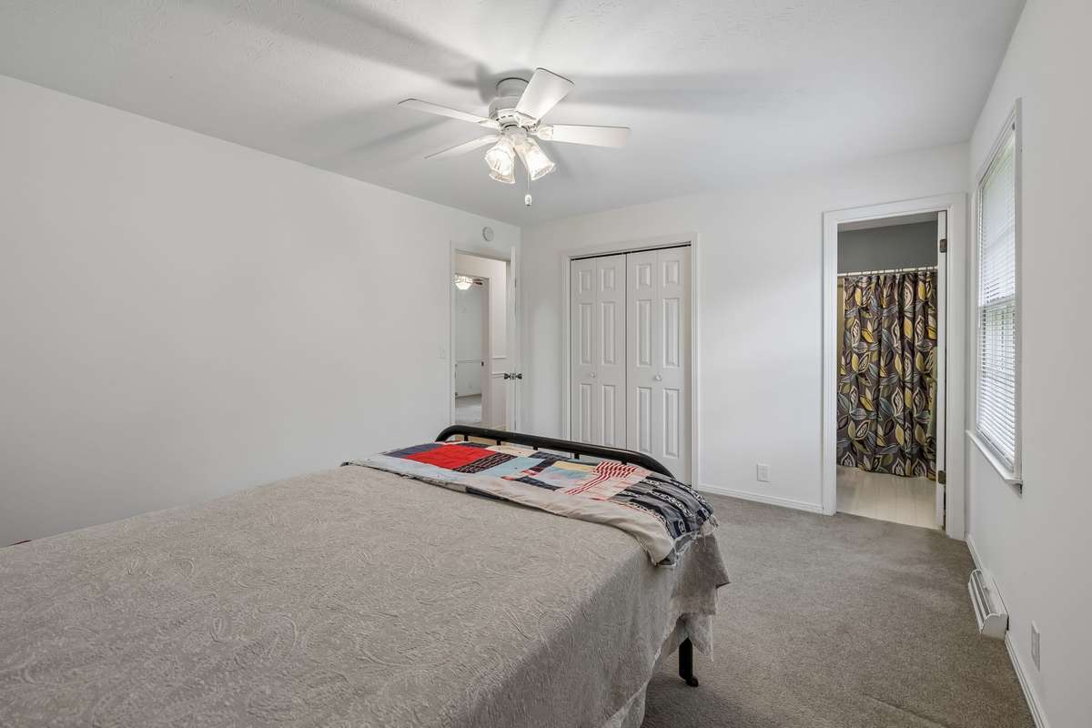 Retreat to the primary suite, where an updated primary bath showcases a clean white vanity, stylish hardware, and a bright, inviting aesthetic.