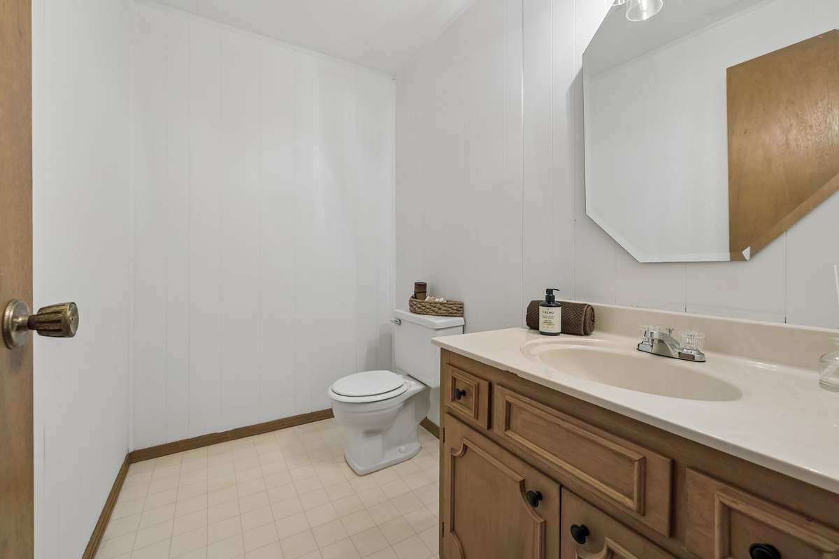 The lower-level half-bath is neatly maintained and easily accessible for guests.
