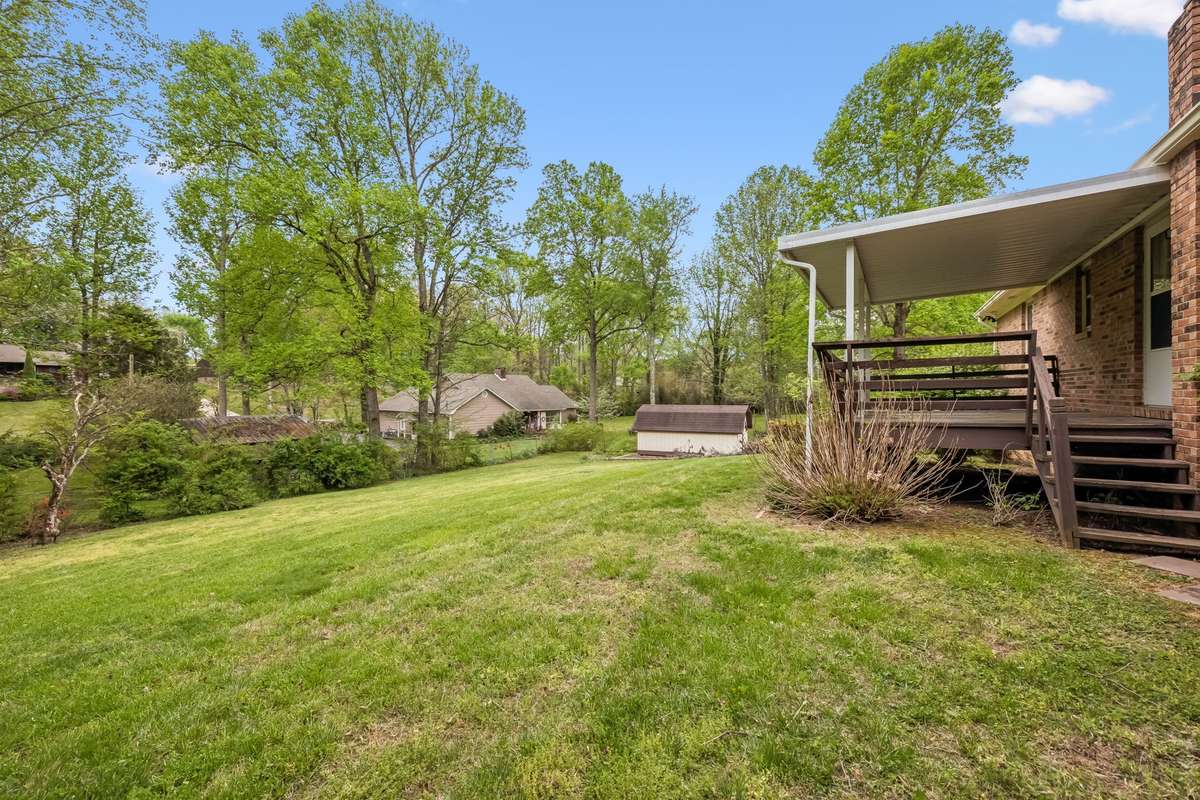 The gently sloped back yard features a stunning, natural view of this picturesque neighborhood.