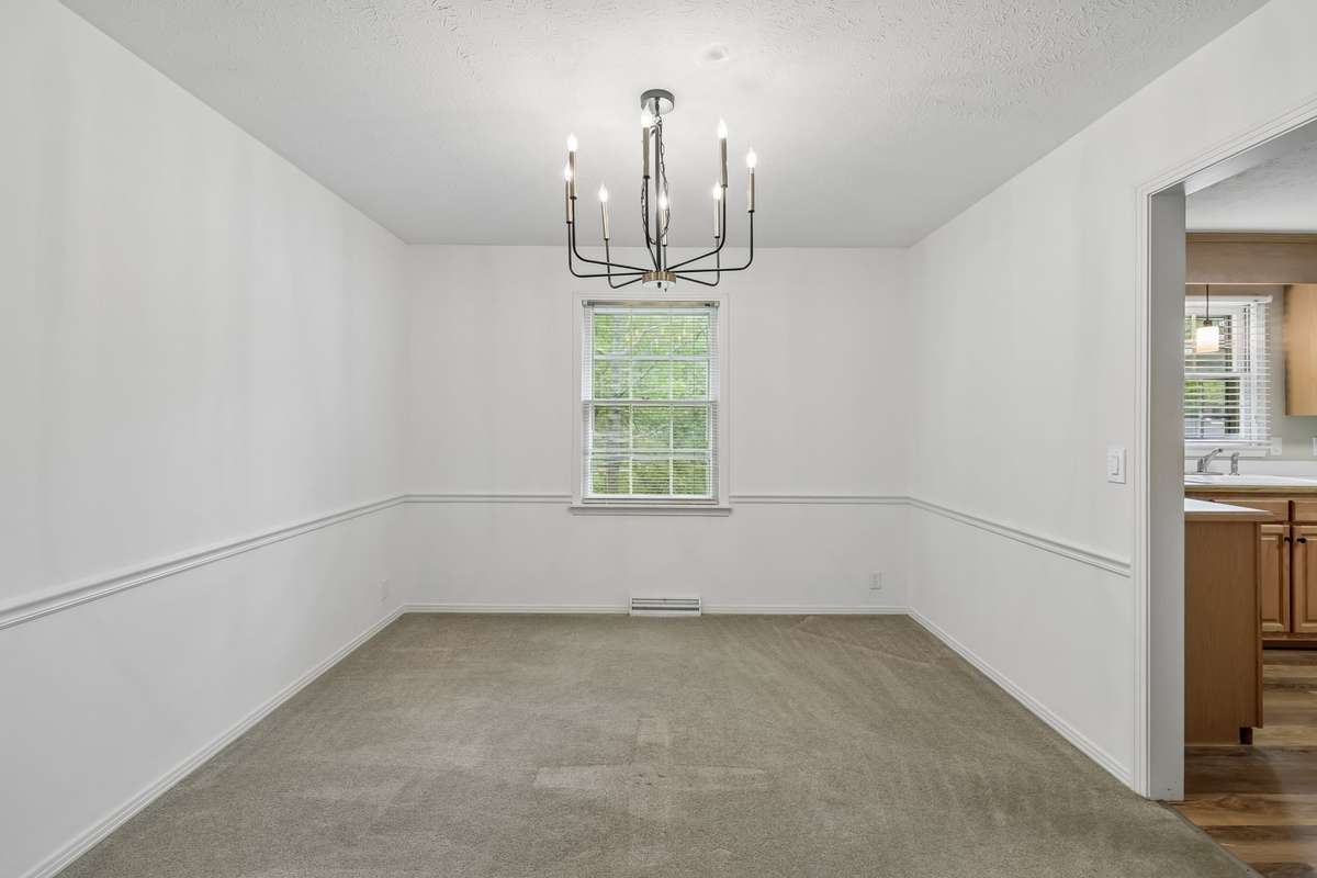 Seamless transitions between the living room and formal dining area make this home ideal for entertaining.
