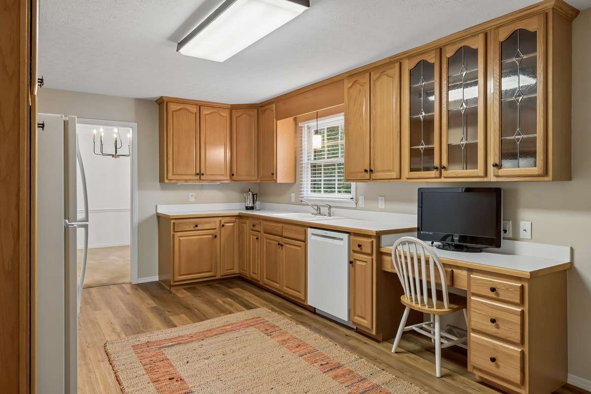 Abundant storage and expansive countertops make this bright kitchen as practical as it is inviting. A pantry cabinet helps meet all your organizational needs.