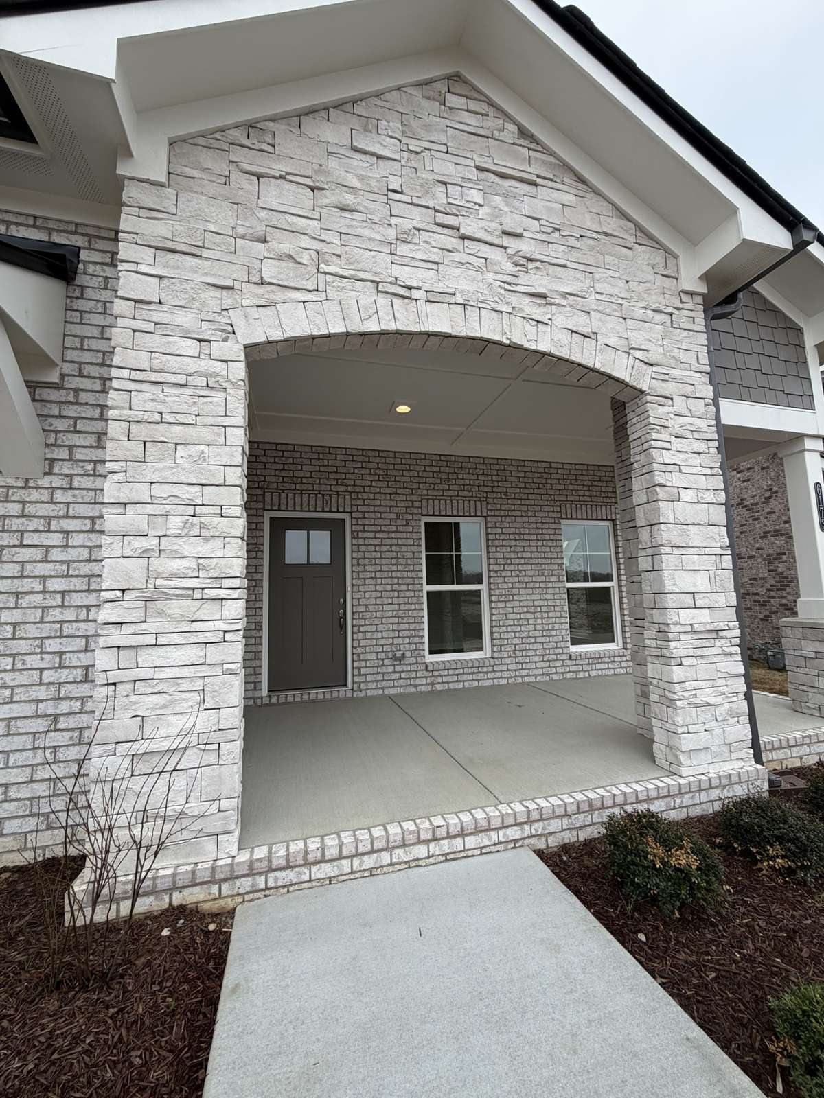 Extra large front porch with beautiful stone archway