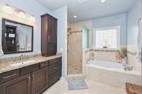 Large soaking tub, double vanities, lots of storage and a custom tile shower with frosted glass for privacy