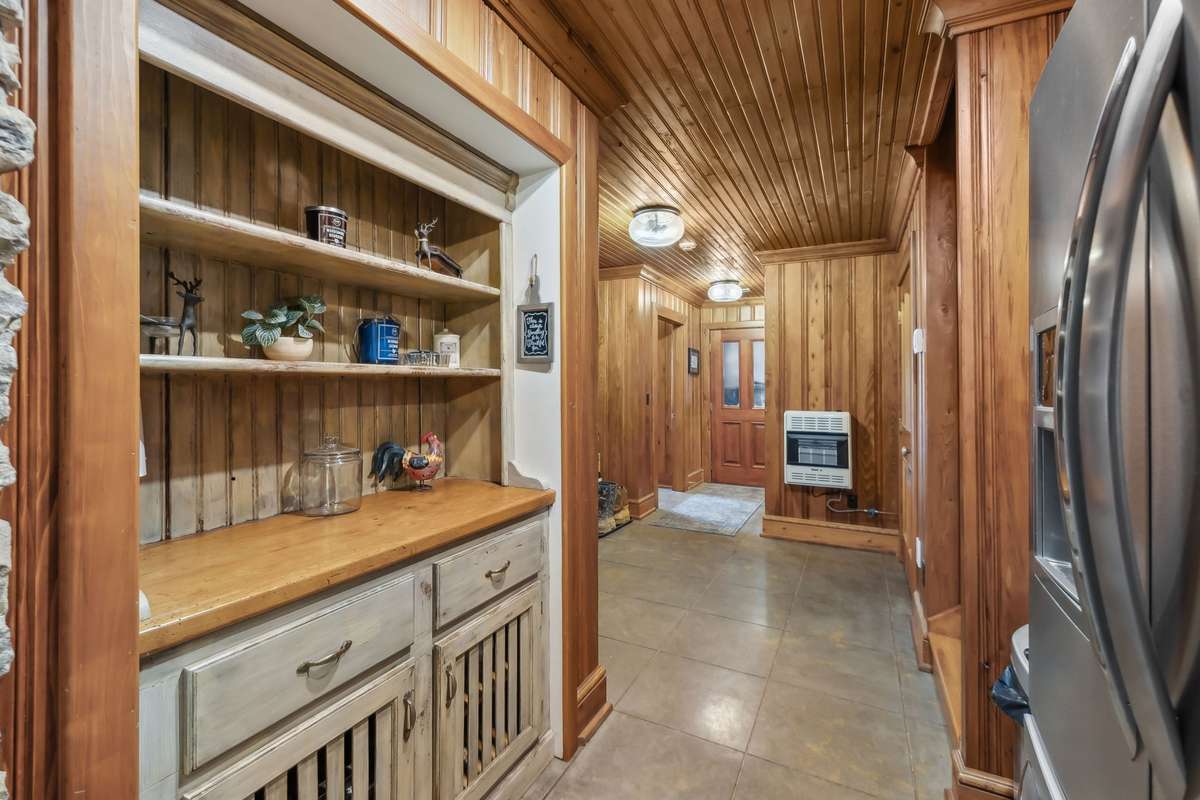 Looking towards the garage entry, laundry room and full bath