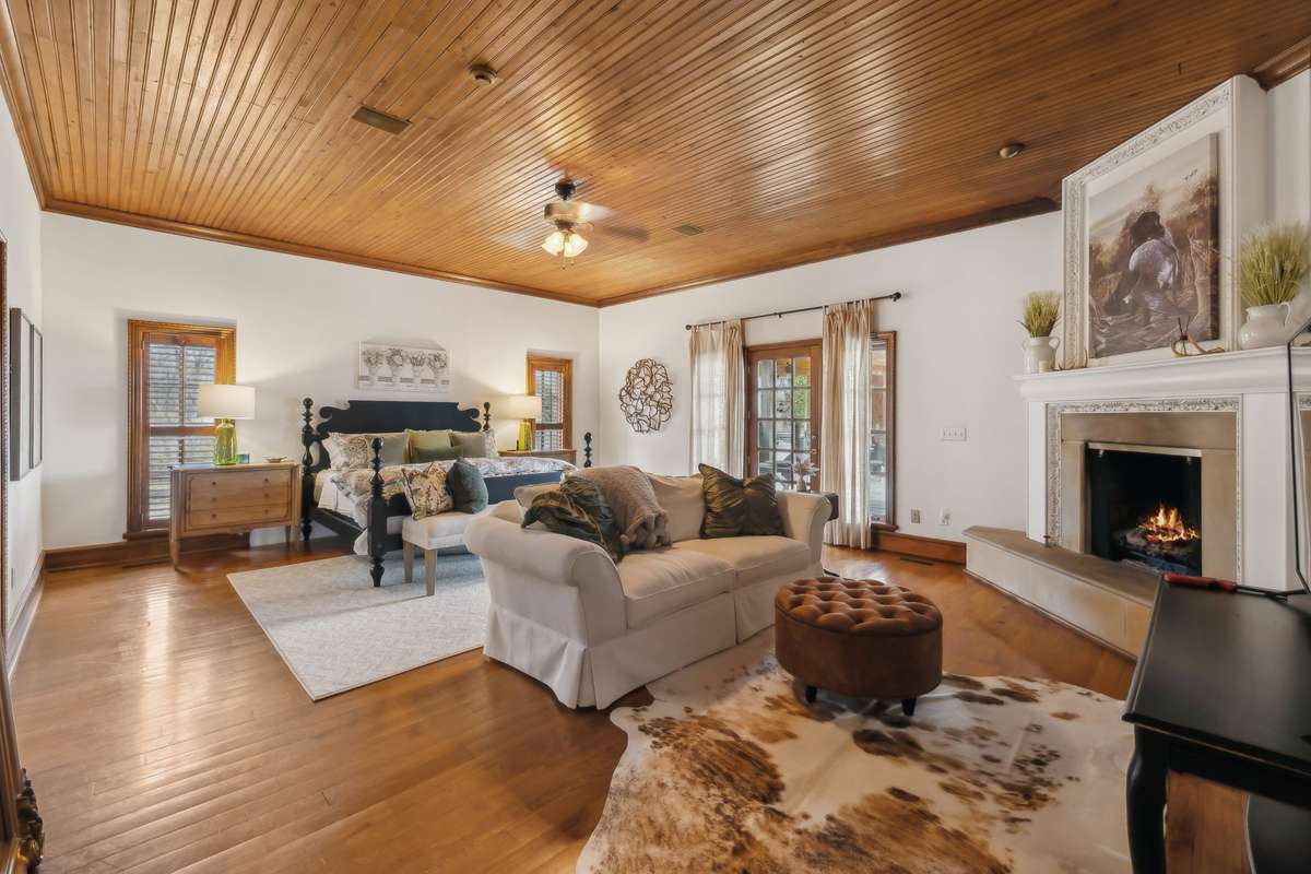 Primary Suite (Wing) is located on main level with a beautiful lake view from the veranda.