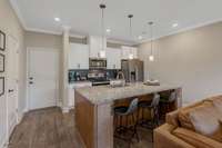 Beautiful kitchen with eat on island packed with storage