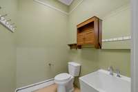 Convenient half bathroom in garage with utility sink.