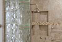 Privacy glass detail between the shower area and the garden tub.