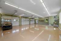 Expansive garage space with polished floors, multiple bays, and endless possibilities for hobbies, storage, or workshop use.