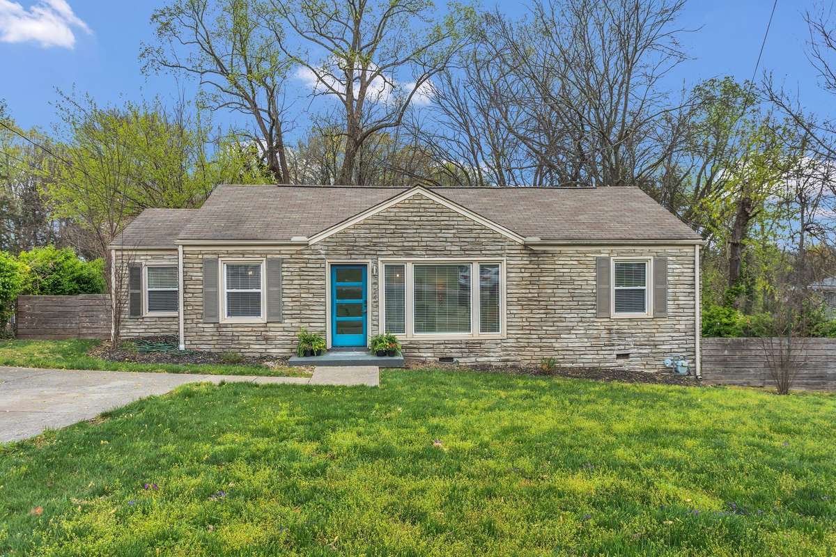 Charming fenced back yard with detached concrete storage building.