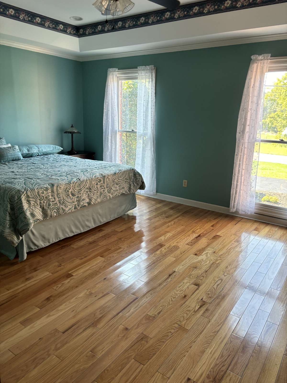 Your large primary bedroom has a tray ceiling and abundant natural lighting.