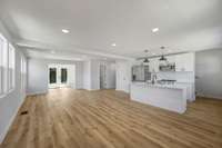 A view across the open living, dining and kitchen area from the dining area.