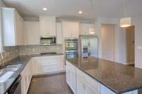 Laundry, mudroom, pantry, and garage access located off the kitchen