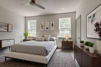 Secondary bedroom with two windows, overhead lighting and wood flooring. **This photo is virtually staged**